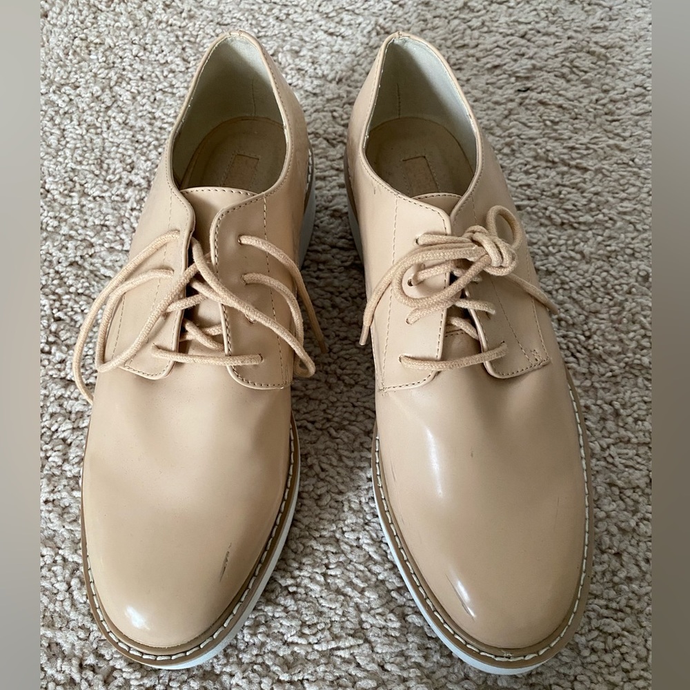 Tan faux leather tie-up platform loafers.